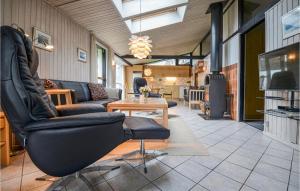 a living room with a couch and a table at Amazing Home In Ebeltoft With Sauna in Ebeltoft