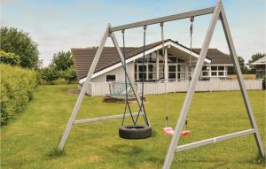 a swing in a yard in front of a house at Holiday Home Strandparken Dnmk Ii in Otterup