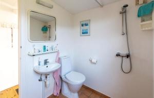 a bathroom with a toilet and a sink at Holiday Home Klirevej Kalundborg V in Bjørnstrup +14 photos