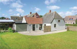 a large white house with a yard at Nice Home In Rudkbing With Kitchen in Spodsbjerg