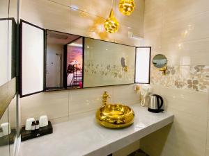 a bathroom with a gold sink on a counter at J Boutique Hotel 新张优惠 in Muar