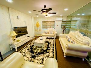 a living room with white couches and a table at J Boutique Hotel 新张优惠 in Muar