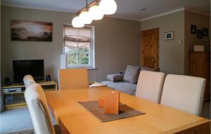 a living room with a table and a couch at 2 Bedroom Gorgeous Home In Hohenkirchen in Hohenkirchen +6 photos