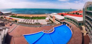an overhead view of a large blue pool on the beach at Ramada by Wyndham Baku in Baku