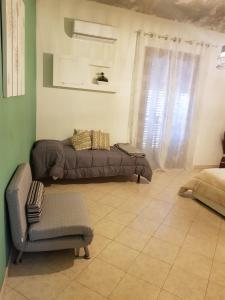 a living room with a couch and a chair at Ai Carrettieri della Cattedrale in Palermo