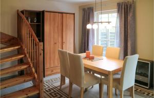 a dining room with a wooden table and chairs at 2 Bedroom Gorgeous Home In Hohenkirchen in Hohenkirchen