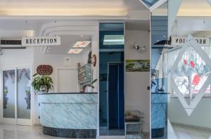 a lobby of a building with a reception counter at Hotel San Paolo in Rimini