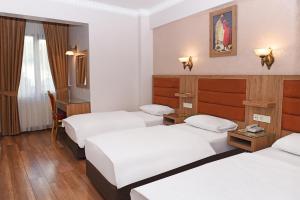 Postel nebo postele na pokoji v ubytování Hotel Grand Umit