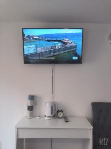 a flat screen tv hanging on a wall at Flat 1 - Entire Modern Studio with en-suite and free Parking close to QMC, City centre & Notts Uni in Nottingham