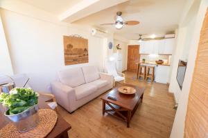 a living room with a white couch and a table at CITY CENTER NEXT TO THE BEACH 2 BEDROOMs APARTMENT in Málaga