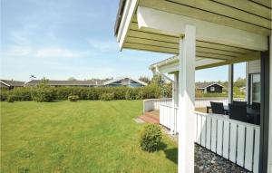 a house with a porch with chairs on a lawn at Holiday Home Elsdyrstien Ca Dnmk in Marielyst