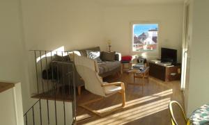 a living room with a bed and a couch and a table at La Maison Bleue in Banyuls-sur-Mer