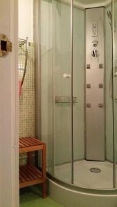 a shower with a glass door in a bathroom at EL CAMPANARIO in Guinicio