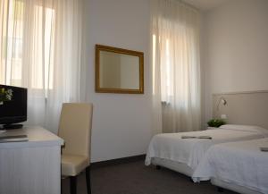 Postel nebo postele na pokoji v ubytování Albergo Accademia