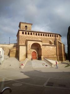 a large brick building with a red door and stairs at DELICIAS in Peraltilla +58 photos