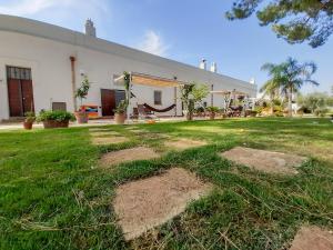 a house with a yard with grass and a building at Agriturismo La Stornara, Petfriendly & EV Friendly in Ginosa Marina +198 photos