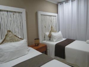 Nkanhi Centro de Conferências e Hotel 객실 침대