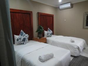 Nkanhi Centro de Conferências e Hotel 객실 침대