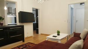 a living room with a couch and a table at E&E Apartments 4* Arena Stožice in Ljubljana