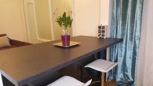 a table with a vase on it with a plant on it at E&E Apartments 4* Arena Stožice in Ljubljana