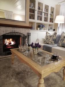 a living room with a couch and a fireplace at Tiree B&B in Johannesburg