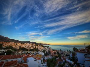 a view of a city and the ocean at sunset at MB Hostels Premium ECO - Adults Recommended in Nerja