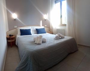 a bedroom with a large bed with towels on it at Hotel Prestige in Rimini