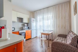 a kitchen with a couch and a table in a room at #Go2SPB - STARS View Apartment SOFIA in Saint Petersburg