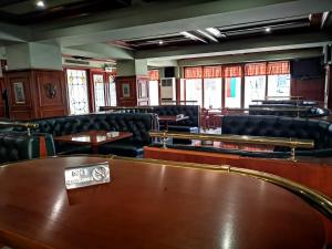 a waiting room with chairs and tables and a table sidx sidx at Tangra Hotel in Stara Zagora