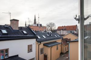 a view of roofs of buildings from a window at Linne Studio in Uppsala