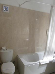 a white toilet sitting next to a bath tub at Arabella Azur Resort in Hurghada