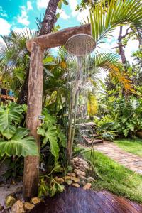 a water fountain in the middle of a garden at Flat Pitanga in Camburi