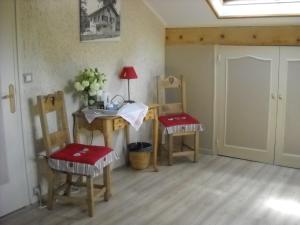 um quarto com duas cadeiras, uma mesa e um lavatório em LA CONTAMINE em Nâves-Parmelan