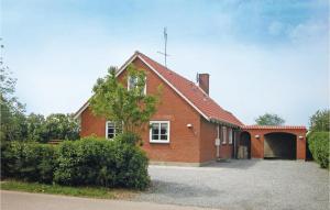 a red brick house with a driveway in front of it at Holiday Home Vesterende V in Ballum
