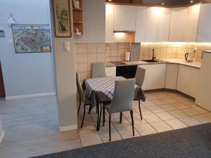 a kitchen with a table and chairs in a room at Toruńska 6 in Gdańsk