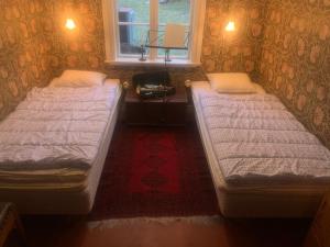 Postel nebo postele na pokoji v ubytování Dränghuset