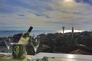 a glass of wine sitting on top of a table at Hotel Historia-Special Category in Istanbul