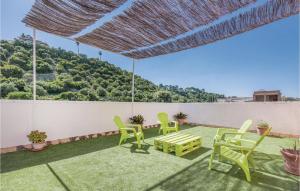 a patio with chairs and a table and a fence at 3 Bedroom Stunning Home In Gelves in Gelves