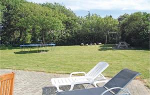 two white chairs and a trampoline in a park at Holiday Home Vesterende V in Ballum