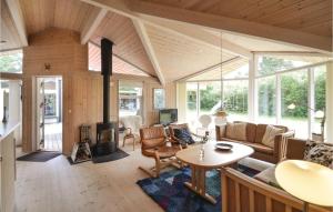 a living room with a couch and a table at Three-Bedroom Holiday Home In Vaggerlose in Marielyst