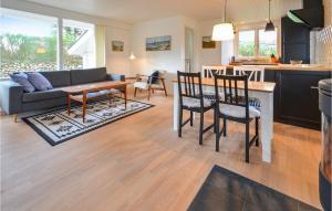 a kitchen and living room with a table and chairs at Lovely Home In Struer With Kitchen in Struer