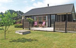 a house with a deck with two chairs on it at Holiday Home Gråandvej Vordingborg Iii in Næs