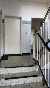 an empty hallway with stairs and a white door at Apartment in zentraler Lage Kassels in Kassel