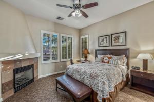 a bedroom with a bed and a fireplace at L48 Premier Location At Clubhouse Condo in La Quinta
