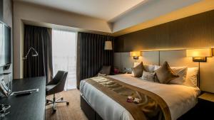 a hotel room with a large bed and a desk at Crowne Plaza Aberdeen Airport by IHG in Dyce