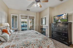 a bedroom with a bed and a dresser with a tv at L48 Premier Location At Clubhouse Condo in La Quinta