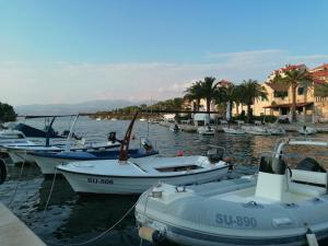a group of boats are docked in a harbor at La Petite Maison in Splitska
