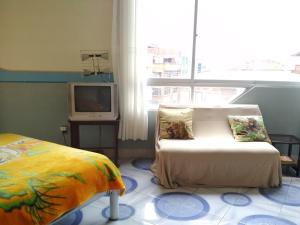 a room with a bed and a couch and a tv at habitación privada y confortable in La Paz