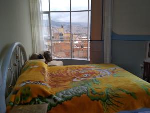 a bedroom with a bed with a painting of a tiger at habitación privada y confortable in La Paz