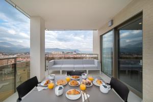 una mesa con platos de comida en la parte superior de un balcón en Ahoy Apartments en El Campello
